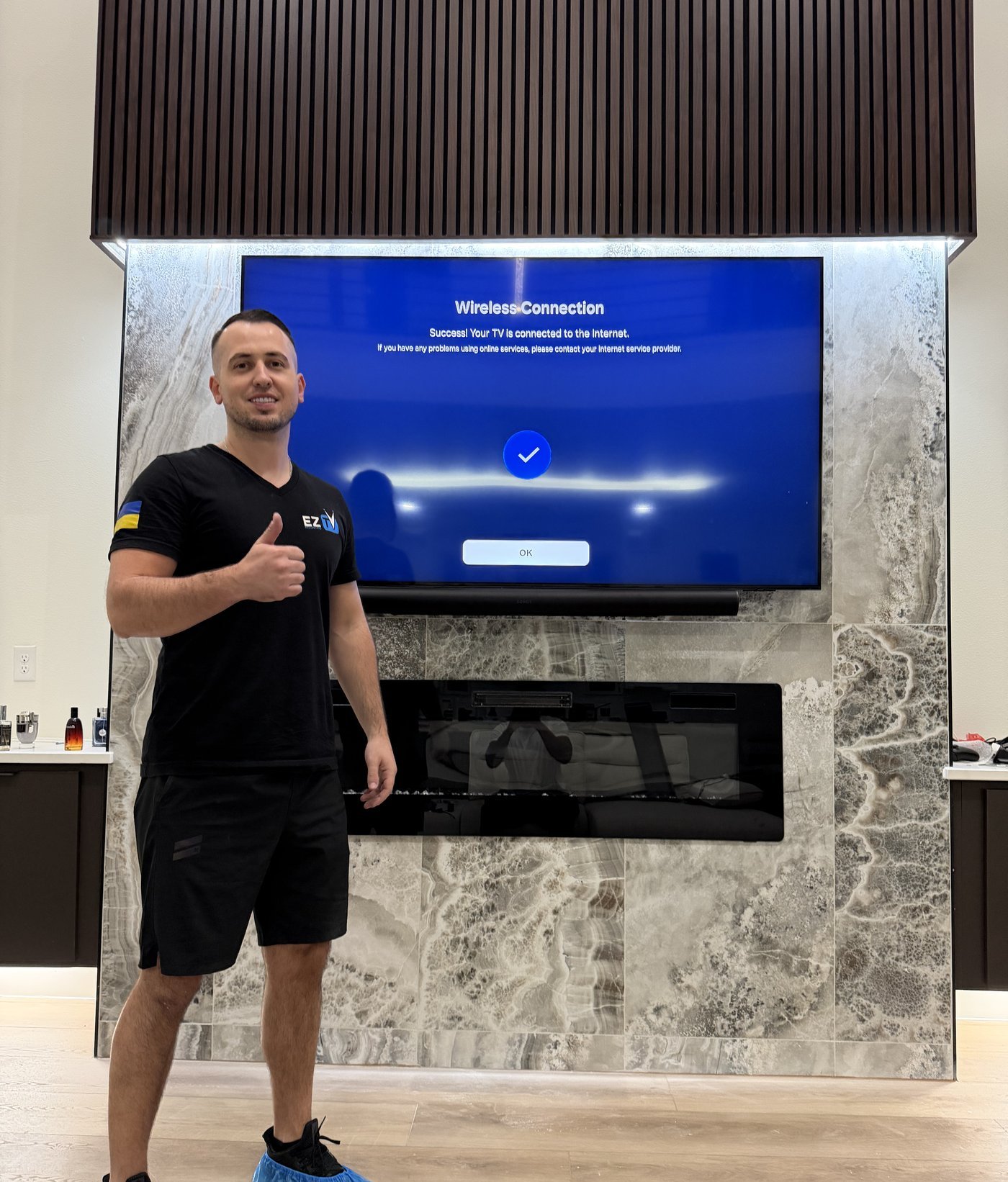 Andriy from EZ TV Mounting with completed marble fireplace TV install Dallas TX