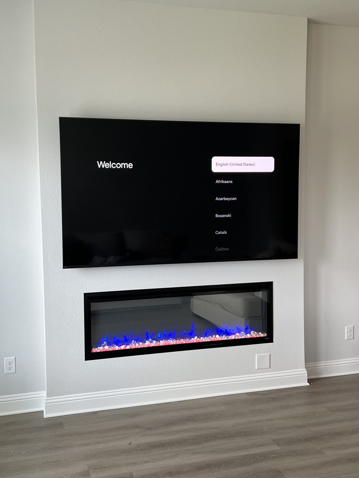 TV mounted above electric fireplace Frisco TX new construction home