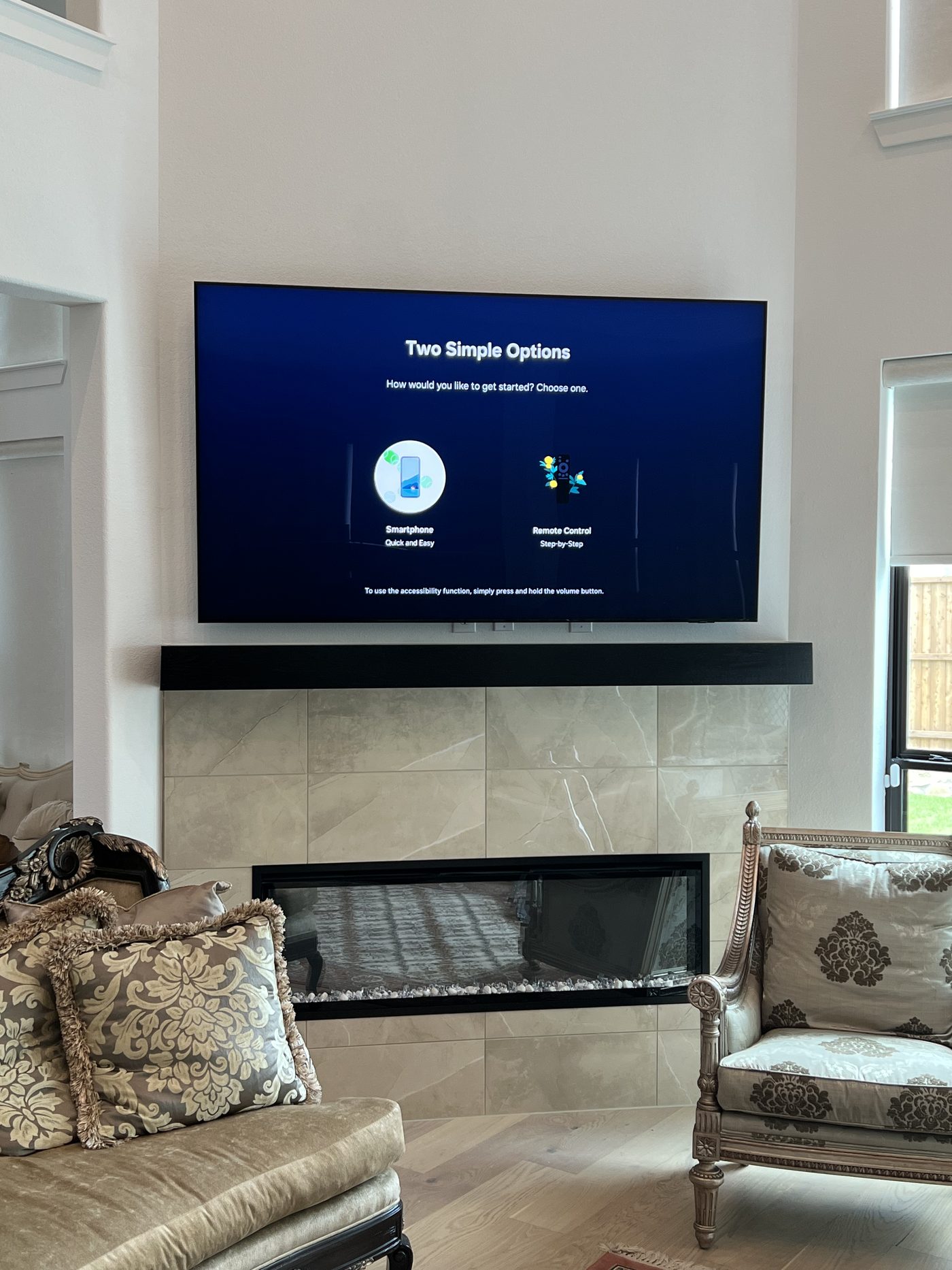 TV mounted above luxury tile fireplace in Dallas TX formal living room - EZ TV Mounting