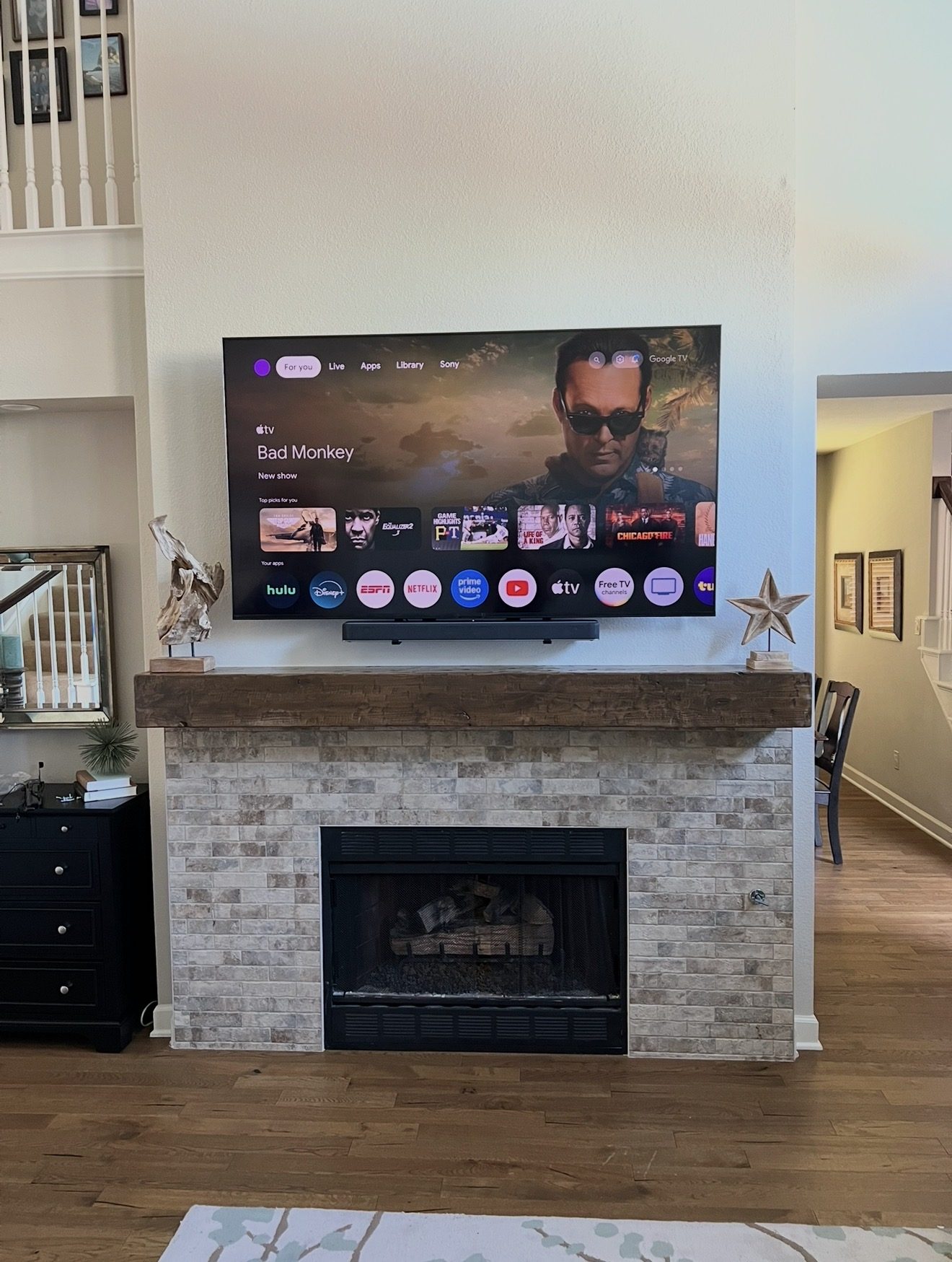 TV and soundbar mounted above brick fireplace Dallas TX - EZ TV Mounting
