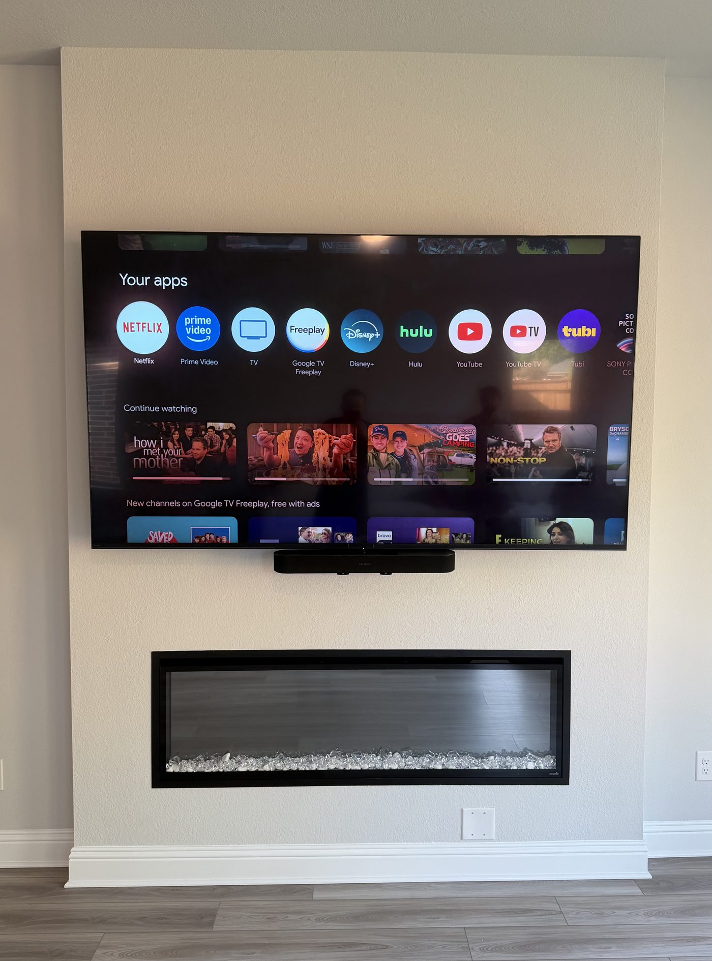 TV and soundbar above modern electric fireplace white wall Dallas TX