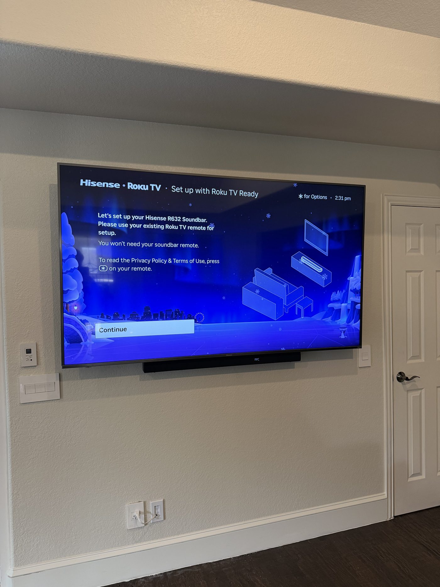 TV and soundbar mounted in luxury wood slat entertainment wall above marble fireplace Dallas TX - EZ TV Mounting