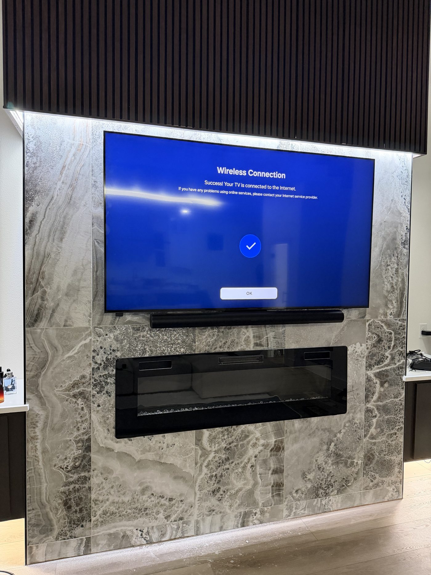 TV and soundbar mounted on marble fireplace surround Dallas TX - no visible cords
